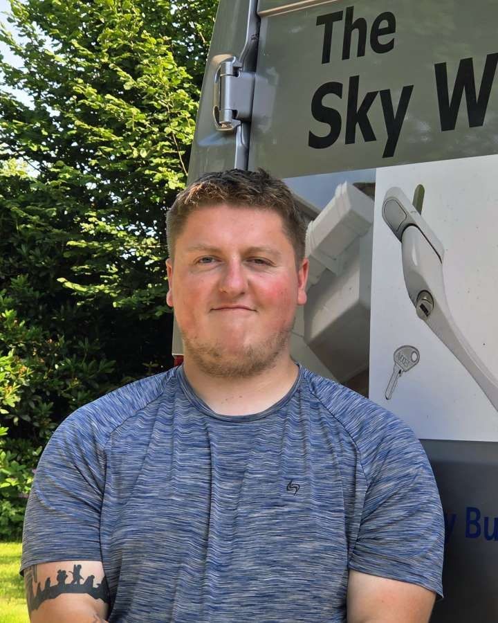Team member photo man with brown hair and a blue tshirt on